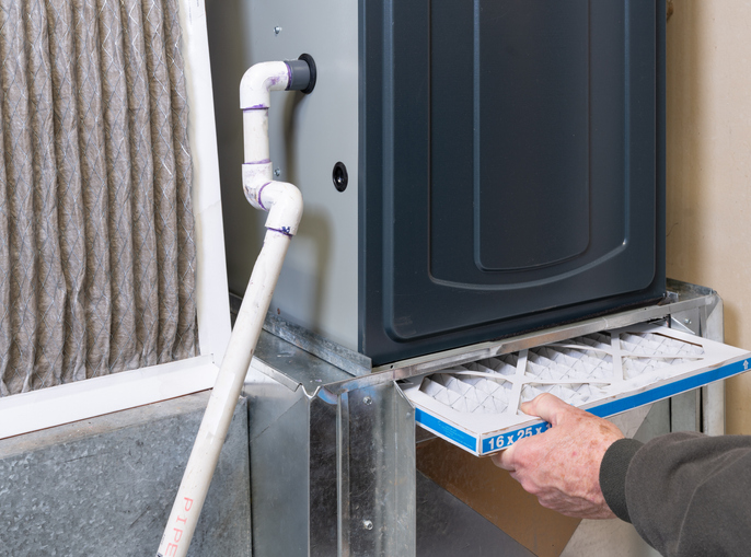 Replacing dirty furnace filter in home | Leto Plumbing & Heating, Inc.