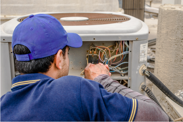 Technician Repairing AC Unit | Leto Plumbing & Heating, Inc.